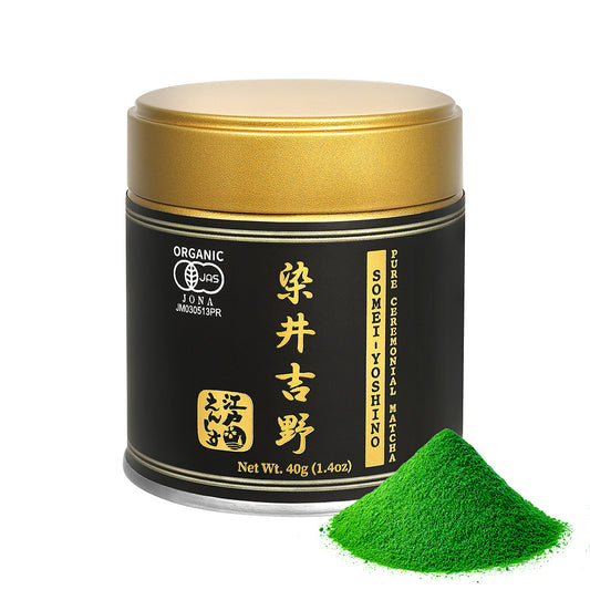 Somei-Yoshino Ceremonial Matcha powder in a black and gold resealable tin with a gold lid, shown with a small pile of the powder on a white background.