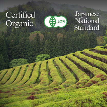 Rows of tea bushes in an open field with distant hills, the JAS mark, and text 'Certified Organic' and 'Japanese National Standard'.