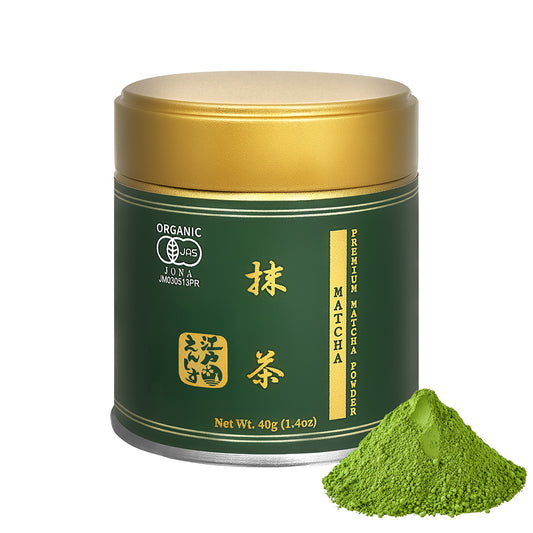 Premium Matcha powder in a green resealable tin with a gold lid, shown with a small pile of the powder on a white background.