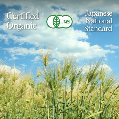 Rows of tea bushes in an open field with distant hills, the JAS mark, and text 'Certified Organic' and 'Japanese National Standard'.