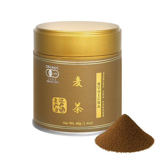 Mugicha barley tea powder in a brown resealable tin with a gold lid, shown with a small pile of the powder on a white background.