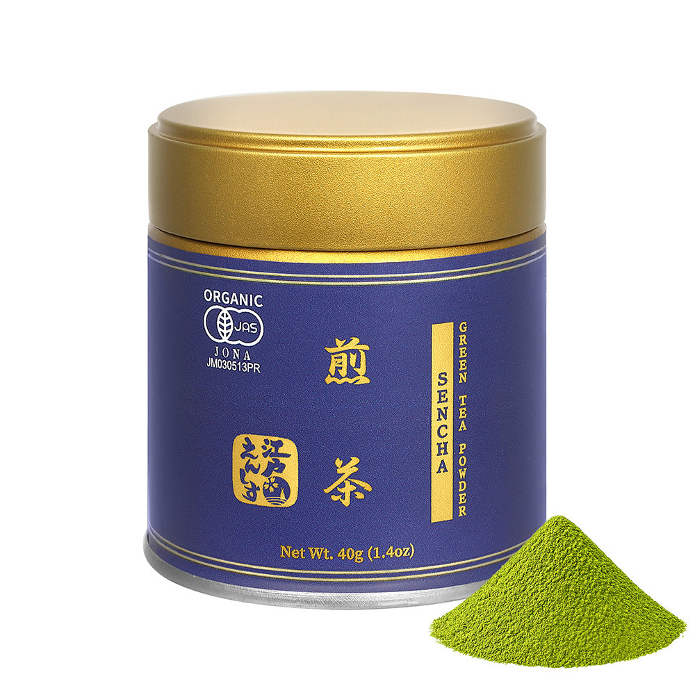 Sencha powder in a dark blue resealable tin with a gold lid, shown with a small pile of the powder on a white background.