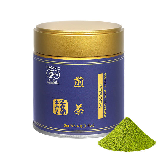 Sencha powder in a dark blue resealable tin with a gold lid, shown with a small pile of the powder on a white background.