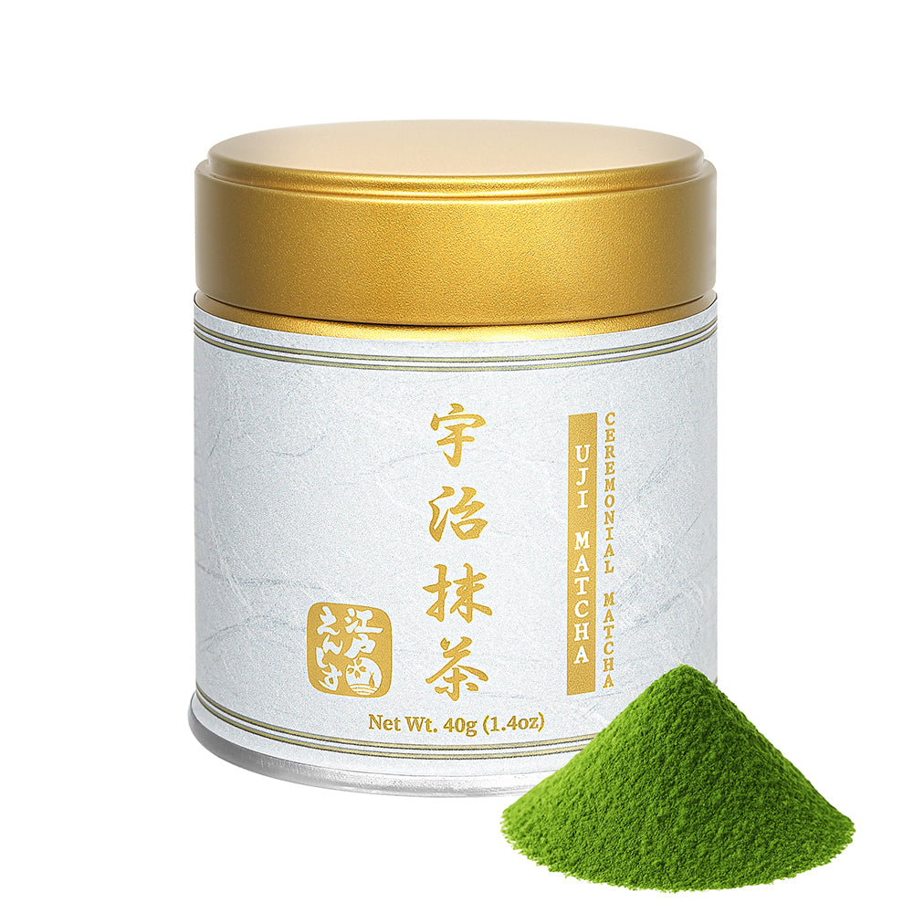 Uji Ceremonial Matcha powder in a white and gold resealable tin with a gold lid, shown with a small pile of the powder on a white background.