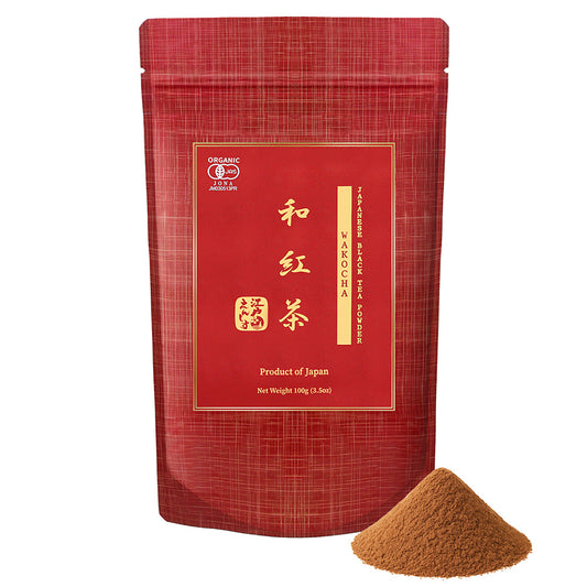 Wakocha Japanese black tea powder in a red resealable stand-up pouch, shown with a small pile of the powder on a white background.