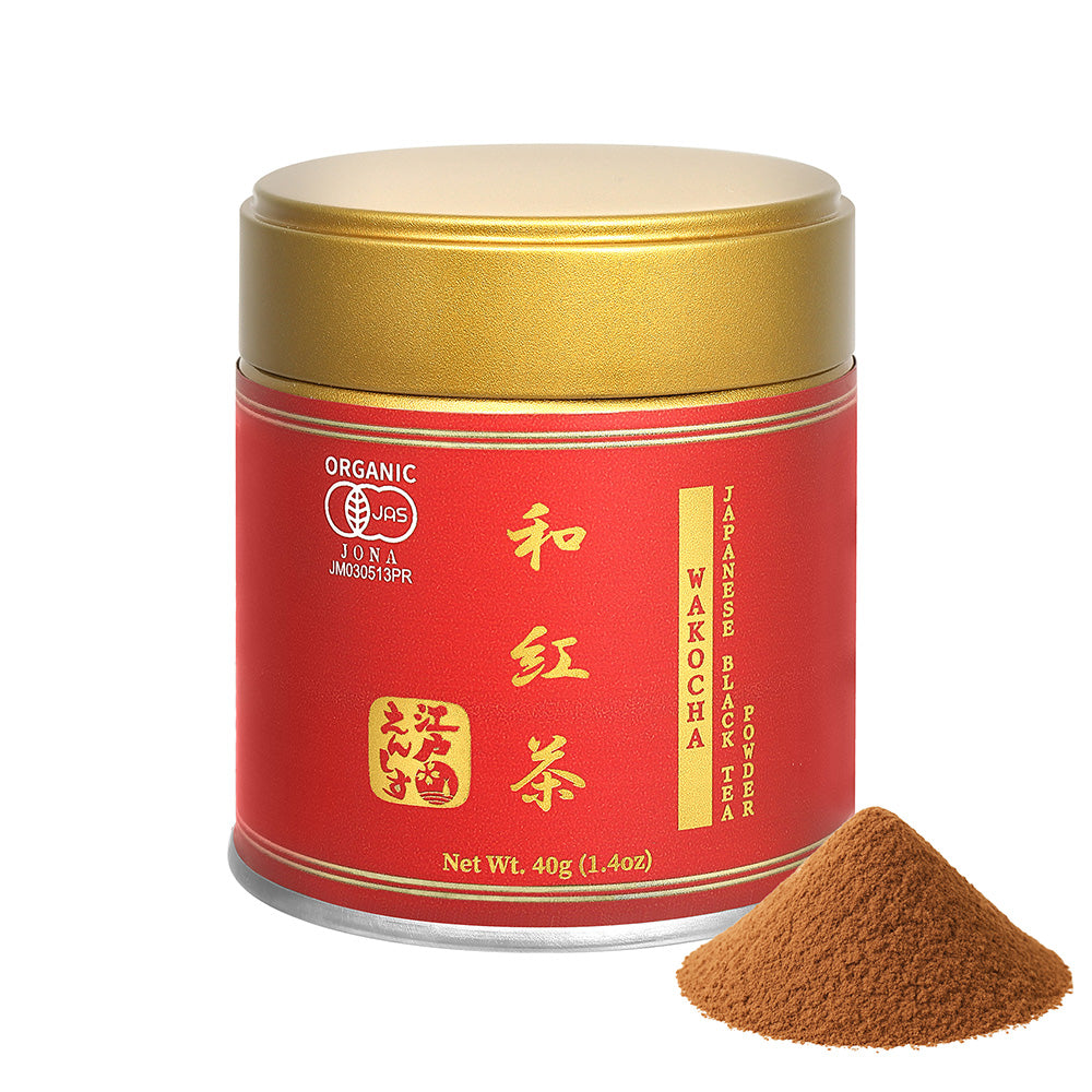 Wakocha Japanese black tea powder in a red resealable tin with a gold lid, shown with a small pile of the powder on a white background.